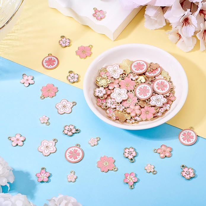 KISSITTY 100Pcs Light Gold Alloy Enamel Charms Cherry Blossom Flower Charm Bulk Gold Plated Pendant Cute Small Floral Dangle Charms for DIY Jewelry Making Kit Bracelet Necklace Keychain Crafts