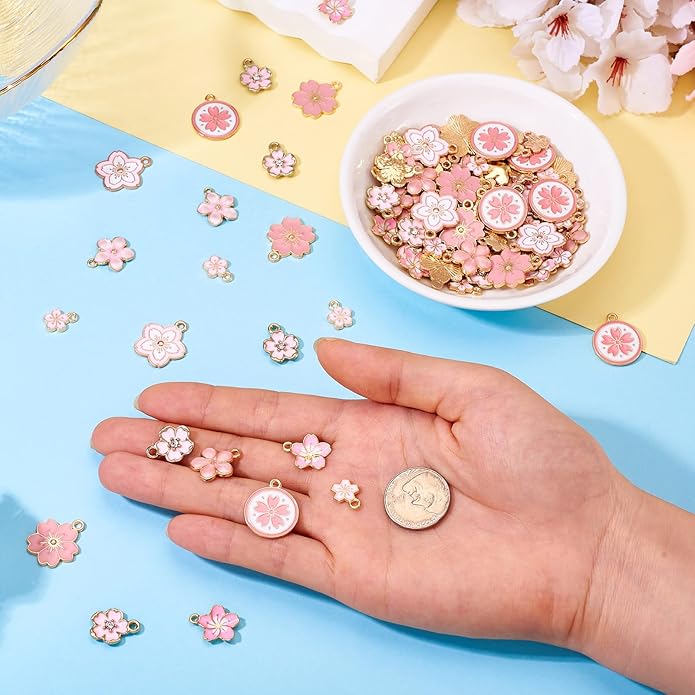 KISSITTY 100Pcs Light Gold Alloy Enamel Charms Cherry Blossom Flower Charm Bulk Gold Plated Pendant Cute Small Floral Dangle Charms for DIY Jewelry Making Kit Bracelet Necklace Keychain Crafts
