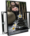 A harmonious black stone stack paired with white and pink flowers bamboo and ceramic vases creates a tranquil Zen decor for minimalist homes and mindful spaces 12x18in Metal blackFramed